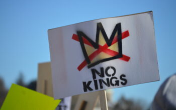 A sign saying "No Kings" is held at a rally in Providence, Rhode Island on Jan. 30, 2026. (Rhode Island In Color)