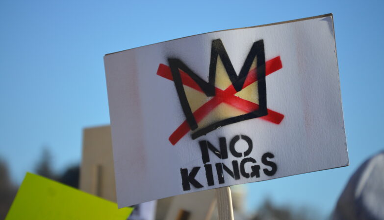A sign saying "No Kings" is held at a rally in Providence, Rhode Island on Jan. 30, 2026. (Rhode Island In Color)